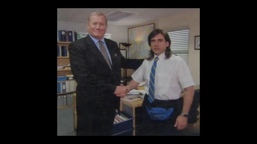 Two men in an office shaking hands